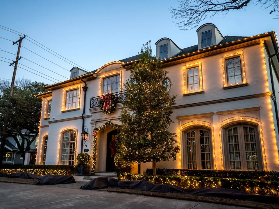 Residential Christmas lighting with roofline and landscape accents